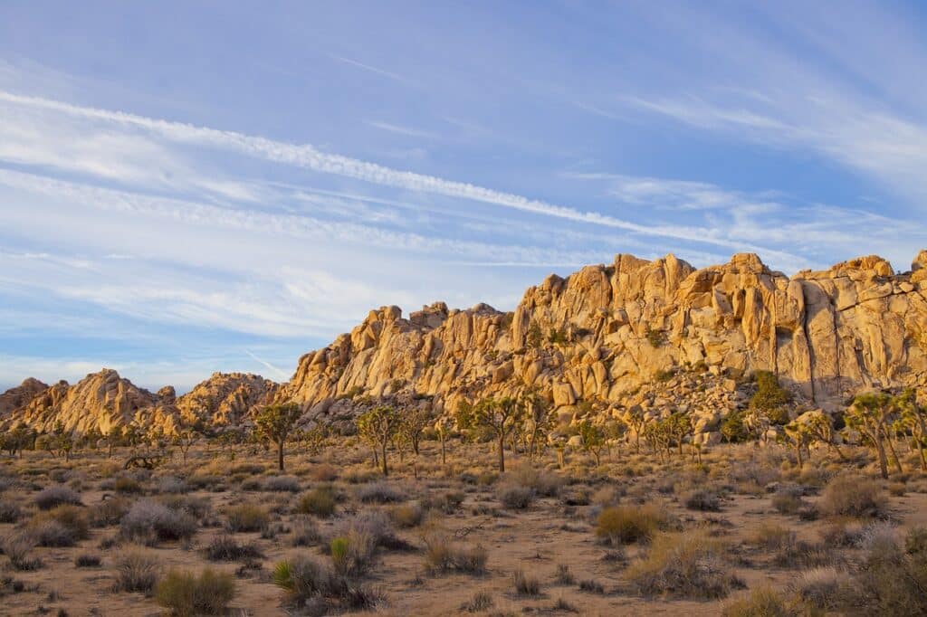 a daytime landscape photo of a huge rock ridge in Joshua Tree National Park. Covered in the Joshua Tree Climbing Guide article
