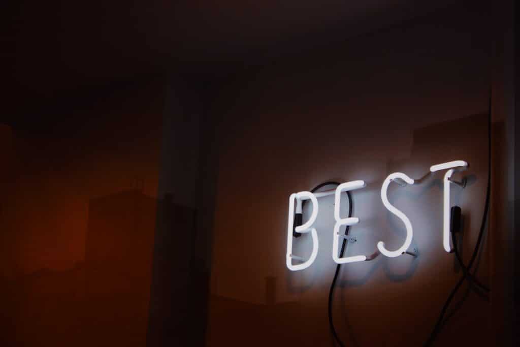 A turned on neon sign spelling out the word 'best', symbolizing choosing the best rock climbing pants
