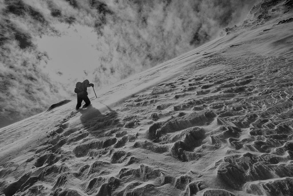 photo of man practicing ice climbing mountaineering on a snowy mountain