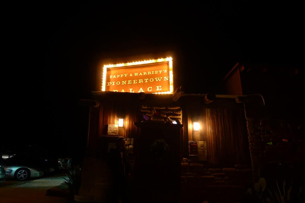 night time photo of Pappy & Harriet's Pioneertown Palace business found in Joshua Tree National Park's surrounding area. Detailed in the Joshua Tree Rock Climbing article.