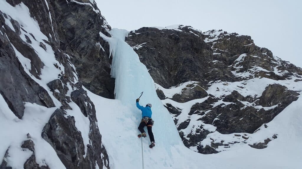 close up shot of a person ice climbing soloing