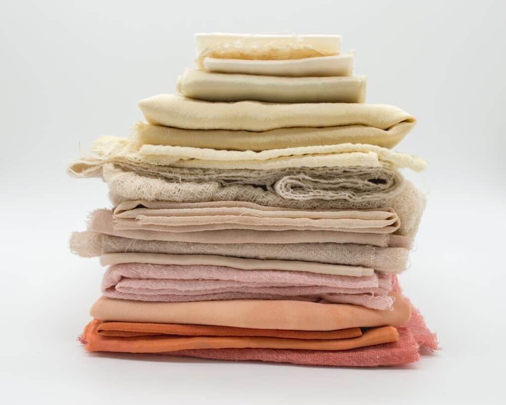 Pile of cloth material, indicating the variability of materials used to make different rock climbing pants
