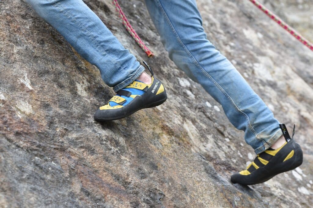 close up of a persons feet as the ascend a rock formation using endurance training skills taught in the multi pitch climbing training article
