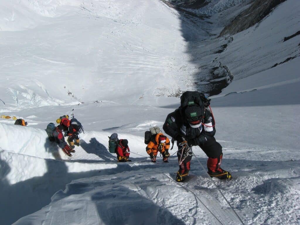 photo of people showcasing necessary techniques needed for ice climbing mountaineering