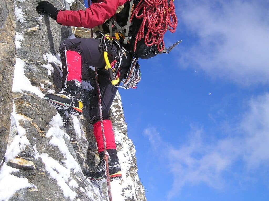 close up of various ice climbing equipment needed for ice climbing mountaineering