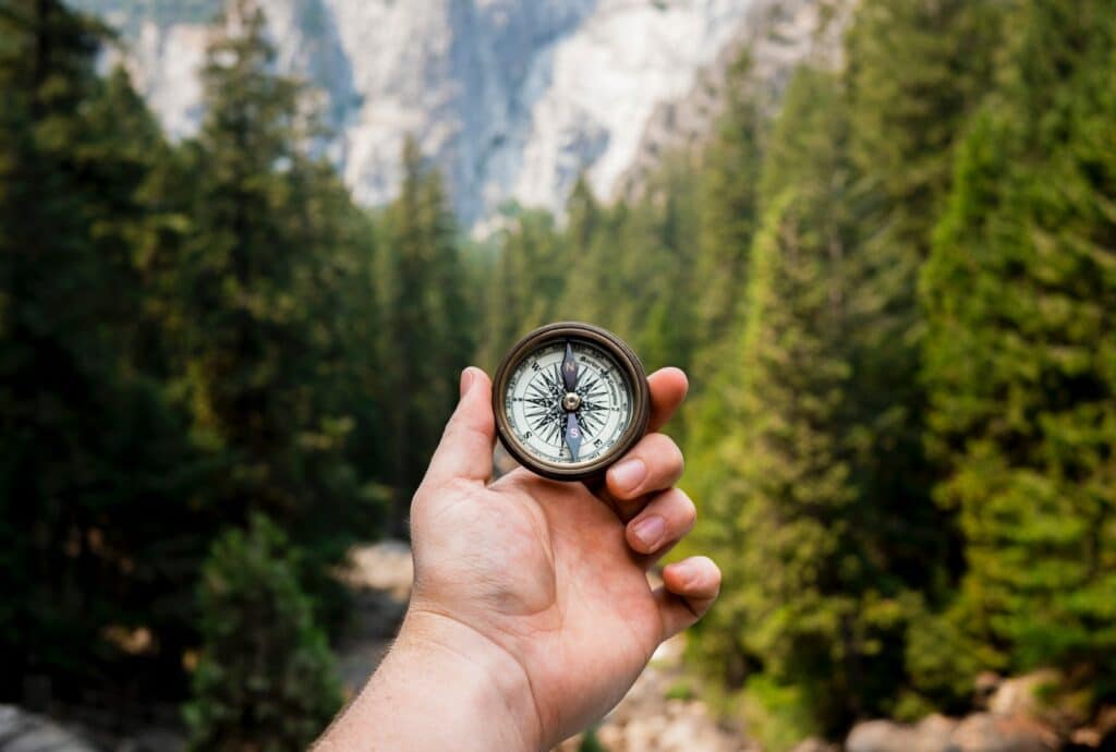 photo of a person holding a compass, meant to symbolize choice in which rock climbing destinations for beginners to choose