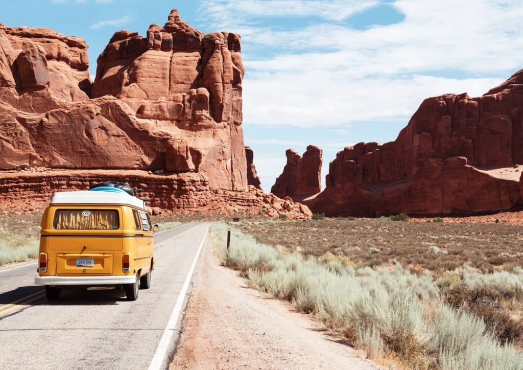 wideshot photo of a camper van headed to red rock