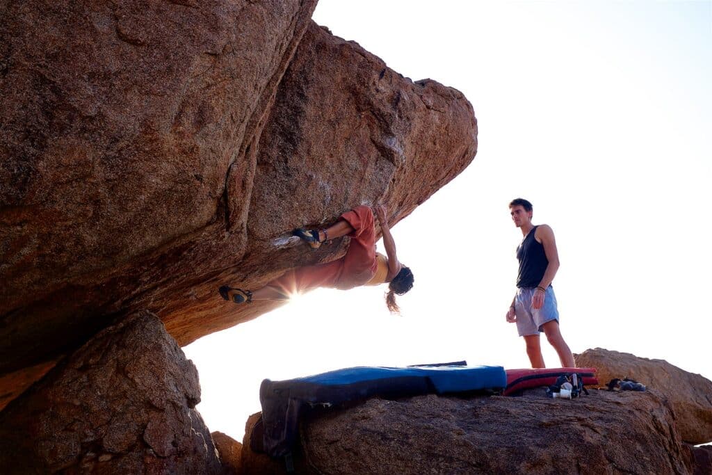 person practicing bouldering techniques at one of the best rock climbing destinations