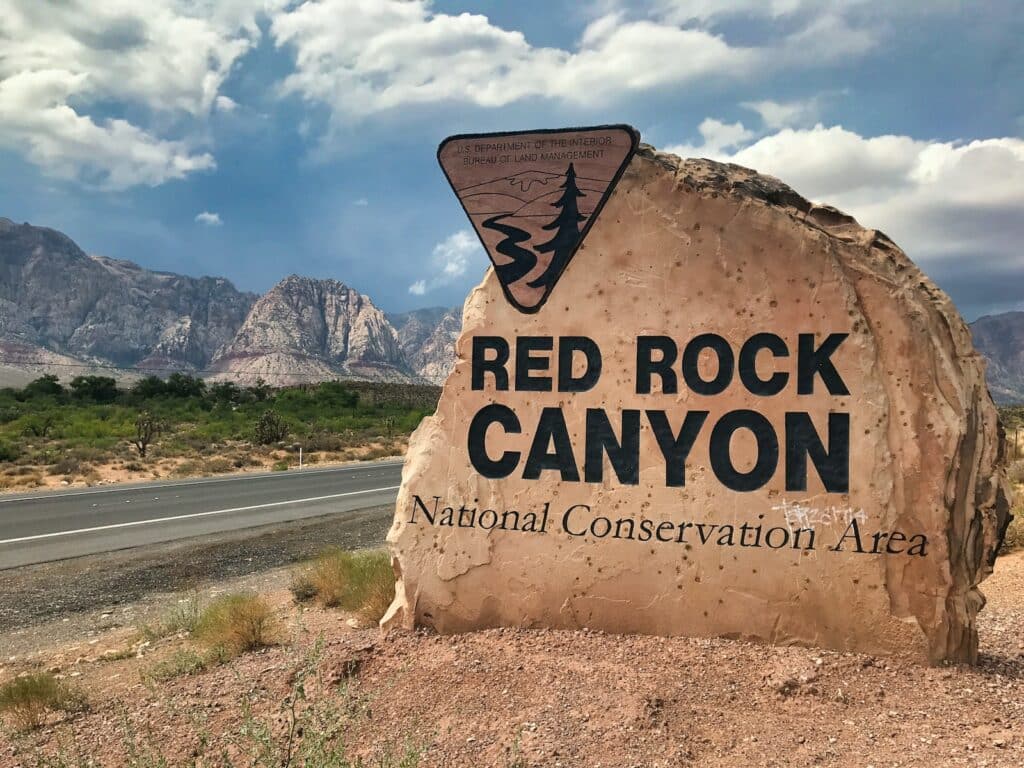 photo of the welcome sign, built on a rock, to red rock canyon