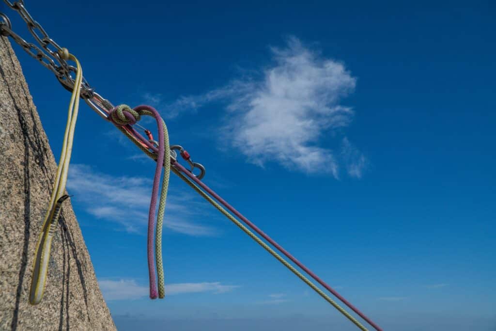 a close up photo of rock climbing rope and gear, depicting the need to adequately care for climbing gear. Covered in the Multi Pitch Climbing Training article.