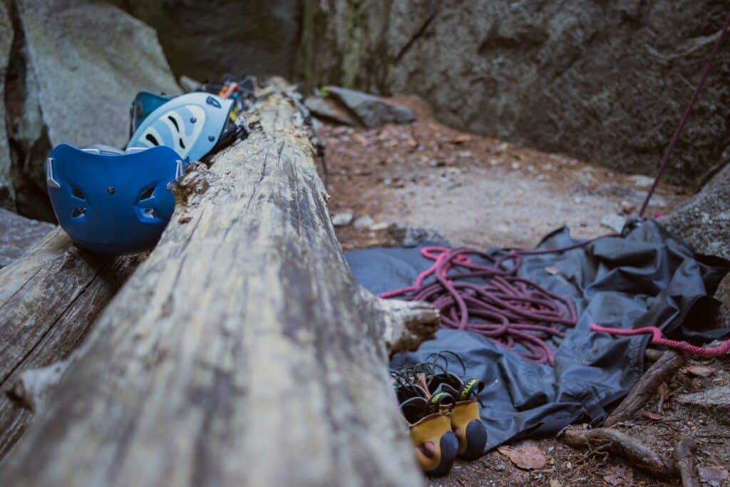 close up photo of helmets, rope and other essential safety gear covered in the rock climbing etiquette article.