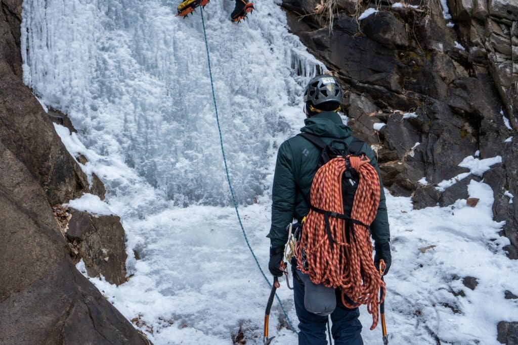 a man seen at the base of a ice formation at another traditional climbing destination