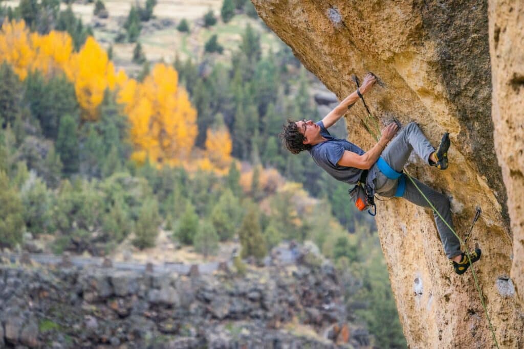 a man sport climbing demonstrating its differences with trad climbing lead climbing